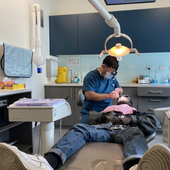 A young person receiving free treatment from a dentist on a Dental Rescue Day